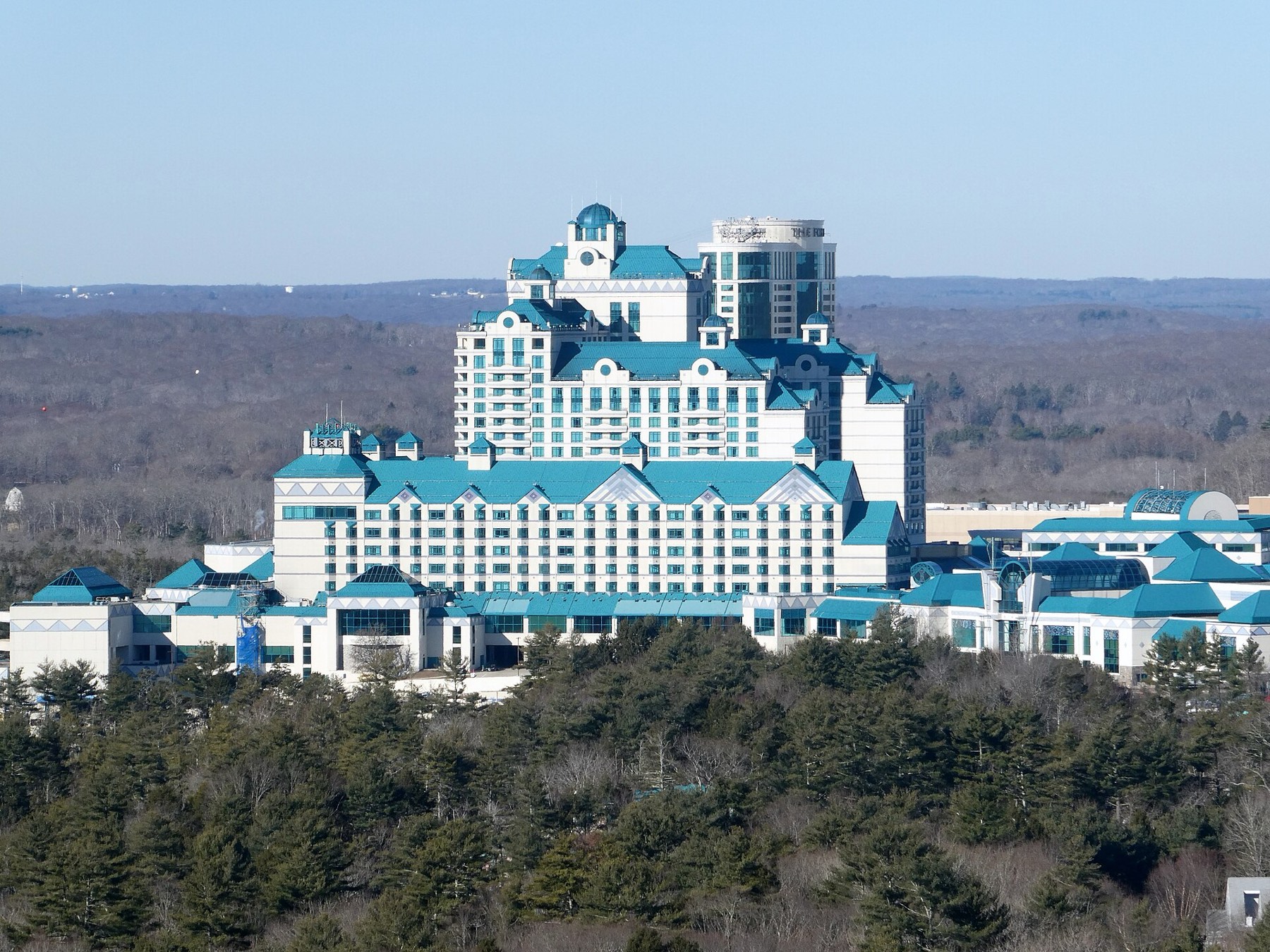 The turquoise-roofed hotel towers of Foxwoods Resort Casino rising above the Connecticut woodland, seen from Lantern Hill